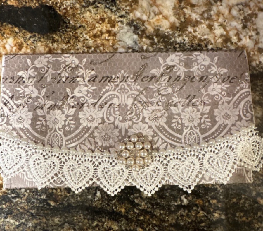 Trifold clutch with lace trim and a pearl-and-crystal embellishment