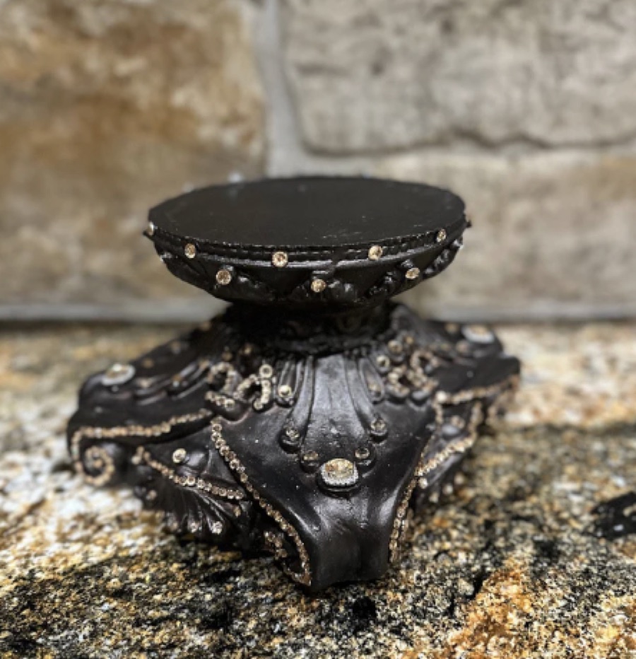 Ornate black candle riser pedestal with jeweled detailing