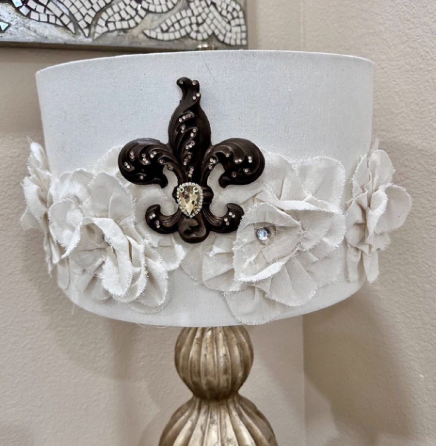 White lampshade with fabric flowers and a fleur-de-lis magnet embellishment